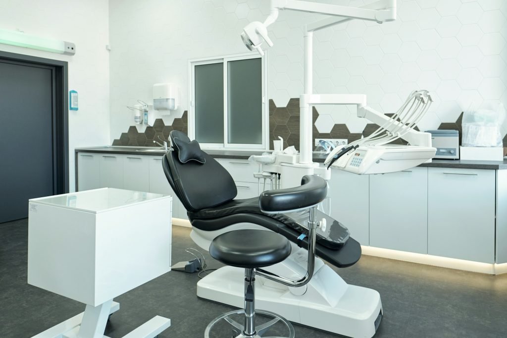 Black leather armchair for patients of modern dental clinics